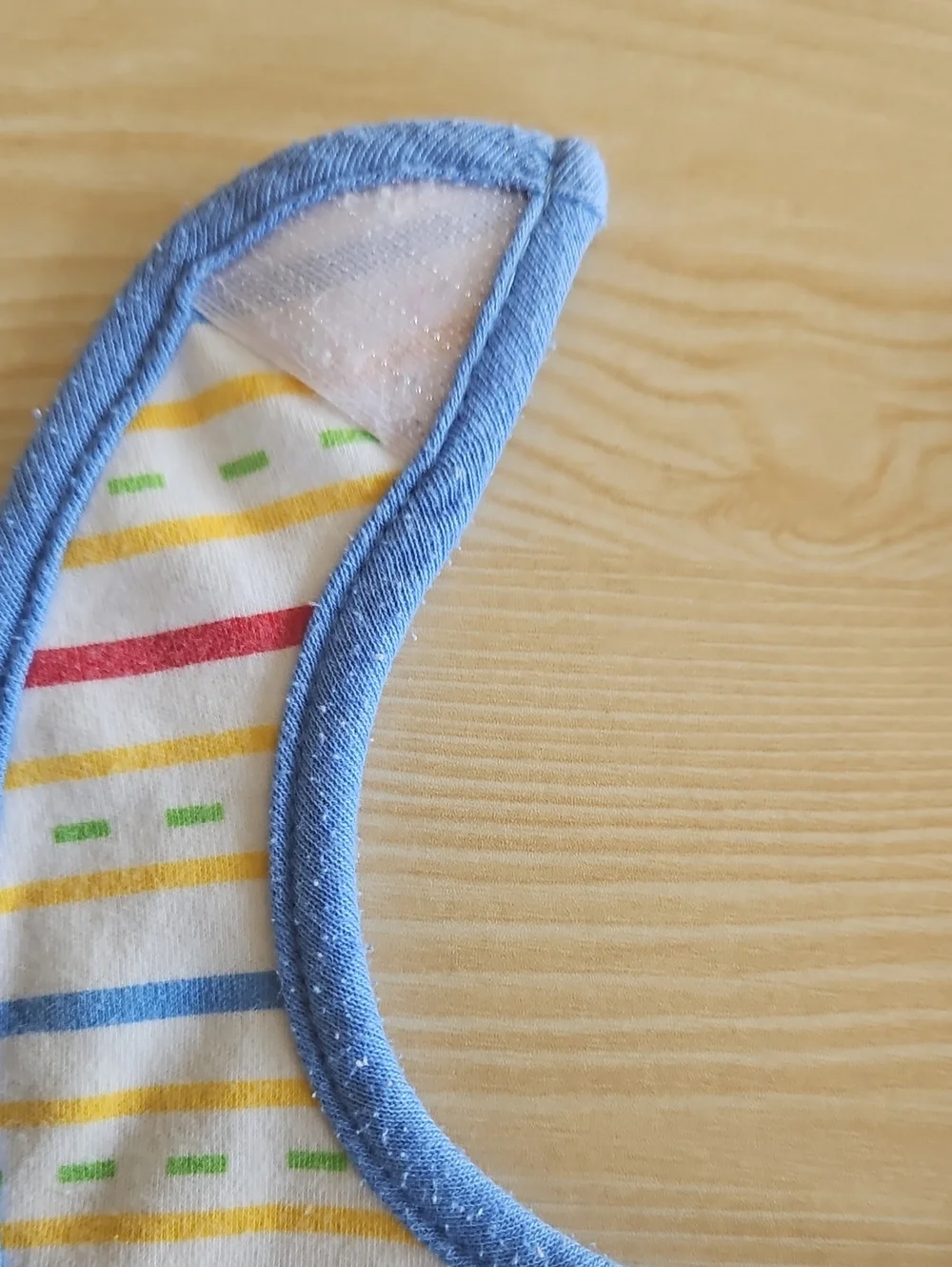 BabiesRUs Striped Bib with Blue Trim and Multicolor Lines